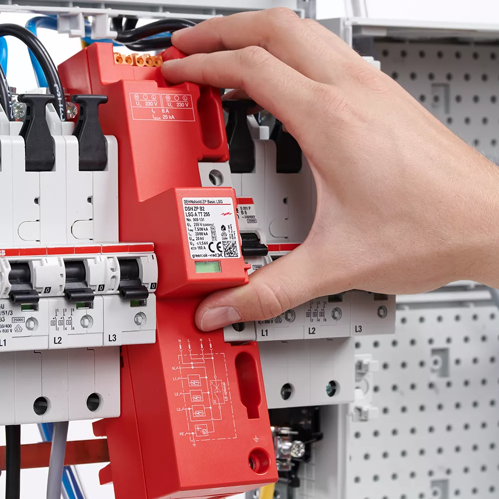 Close-up of an electrical distribution board showing circuit breakers, wiring, and a prominent DEHNshield ZP surge protection device.