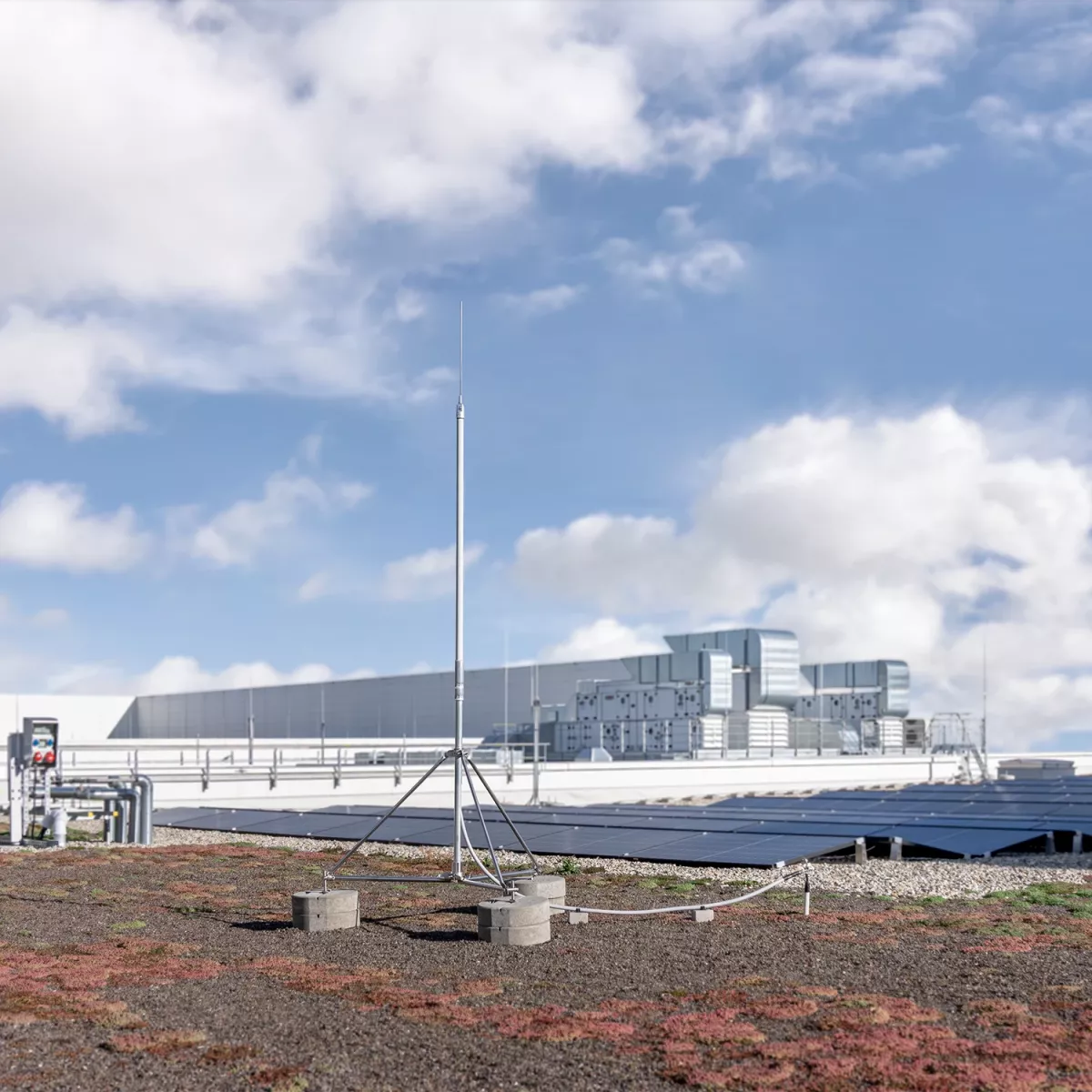 Building with an HVI light plus on the flat roof. A PV system can be seen in the background.