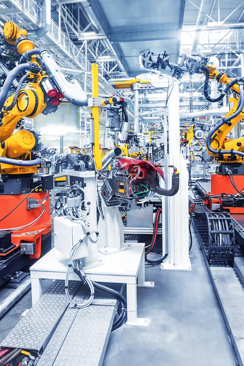 Yellow robots in industrial building